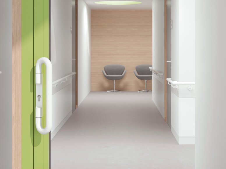 HEWI lever handle signal white Glazed hospital door with green frame equipped with a lever handle in the colour signal white made of polyamide