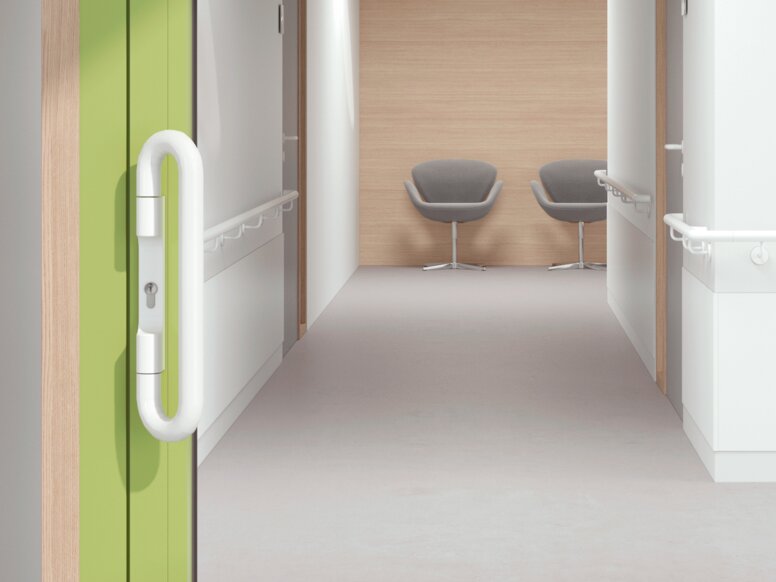 HEWI lever handle signal white Glazed hospital door with green frame equipped with a lever handle in the colour signal white made of polyamide