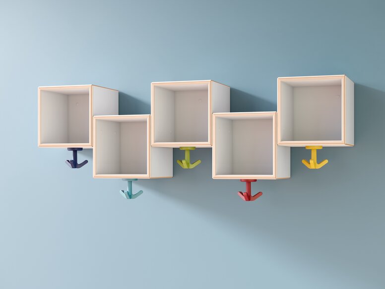 HEWI Triple hook Wall-mounted boxes at different heights, to which colourful triple hooks are attached