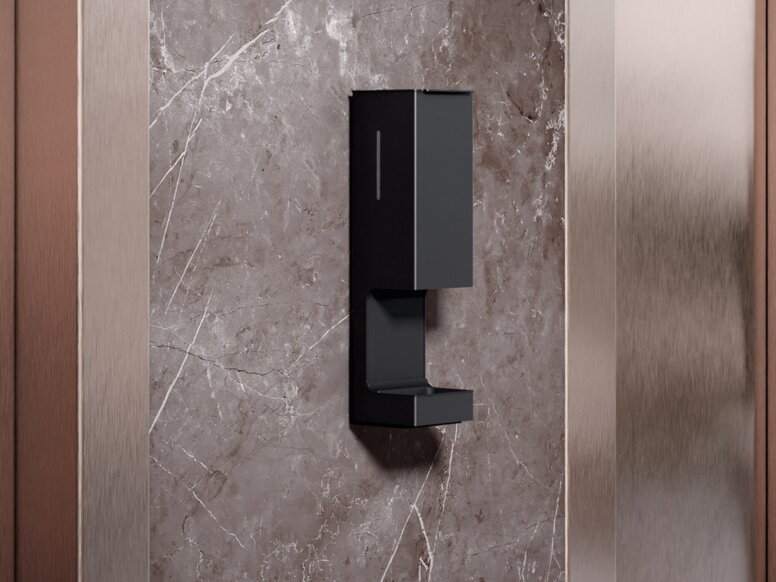 HEWI SENSORIC disinfectant dispenser wall model A touch-free disinfectant dispenser is installed on the wall between two lift doors